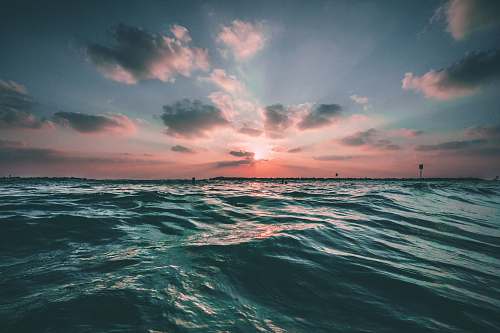 ocean body of water during golden hour sea