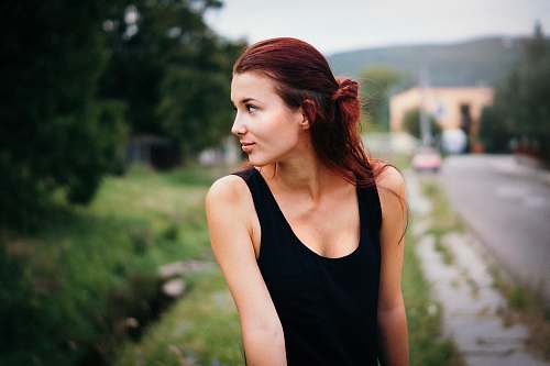 girl depth of field photography of woman in black tank top on street person