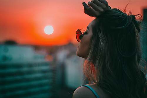 people woman putting her left arm on her forehead person