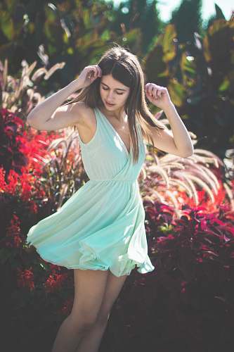 people woman standing in front of bushes person