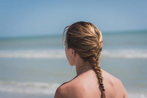 person back view photo of woman with braided hair near sea woman