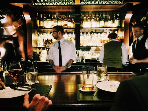 human bartender standing beside table person
