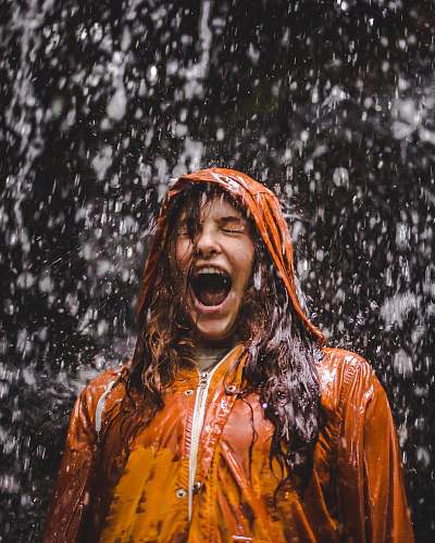 person close-up photo of woman in orange coat human