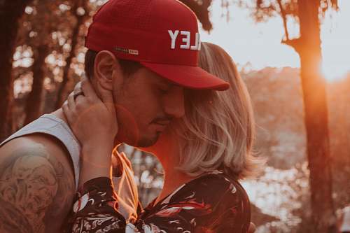 human closeup photo of man and woman hugging each other person