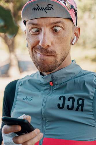 human closeup photo of man holding phone person