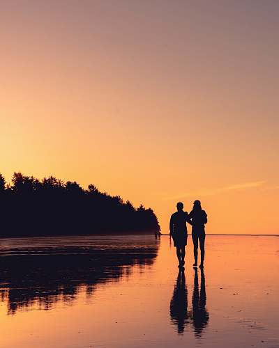 human couple standing on body of water person