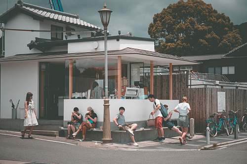 human crowd of people waiting on the corner of the street at daytime person