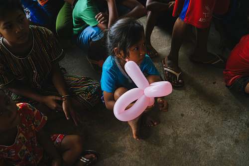 human girl holding a pink balloon person
