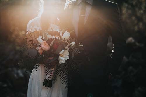 person groom beside bride holding bouquet flowers wedding