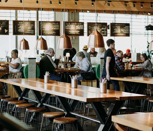 person group of people eating inside cafeteria restaurant