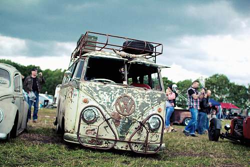 vehicle group of people near Volkswagen T1 on green grass field transportation