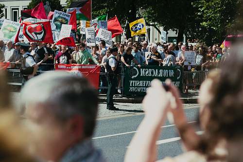 person group of rallyist blocked by police crowd