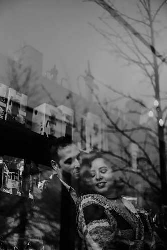 human male holding woman from the back grayscale photo black-and-white