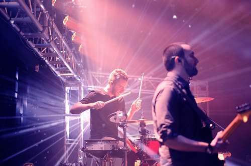 person man playing drums on stage music