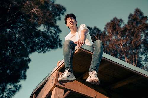 person man sitting on roof human