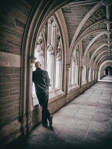 human man standing beside window person