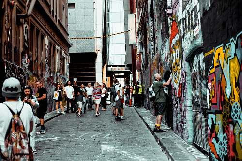 human man standing near concrete building graffiti