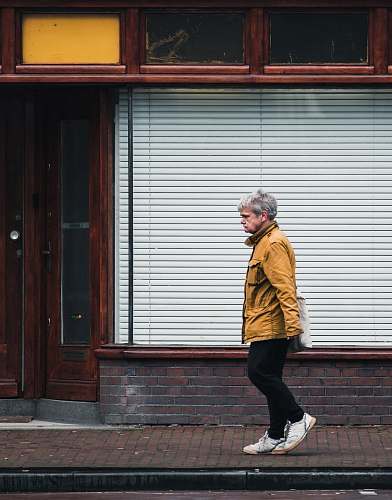 person man walking in front of store human