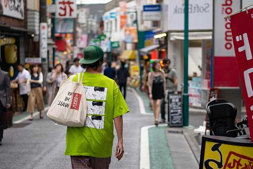 person man walking on street during daytime human