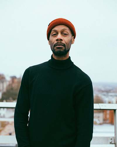 person man wearing black sweater and red knitted cap human