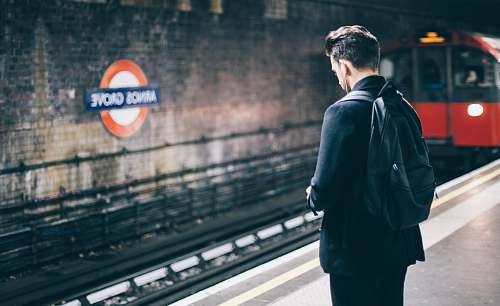 human man with backpack standing on train station person