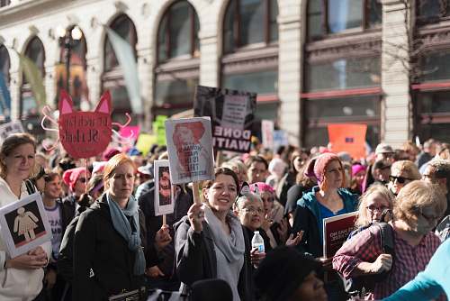 person people holding flyers during daytime crowd