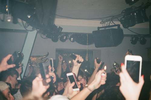 human people raising their hands and holding their smartphones person