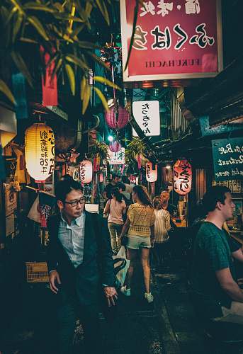 human people walking between building at nighttime japan