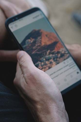 person person holding smartphone turned on human