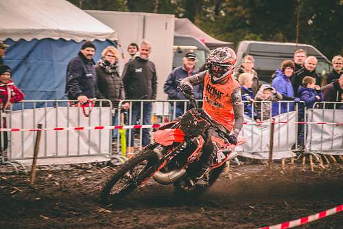human person riding motocross dirt bike person