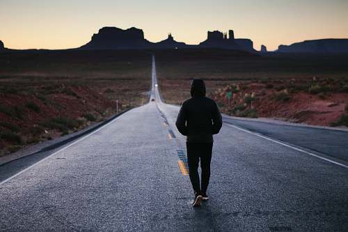 human person walking in the center of the road person