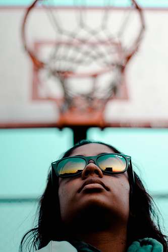 person person wearing black Ray-Ban Wayfarer sunglasses with black frames in worm's eyeview photography during daytime human