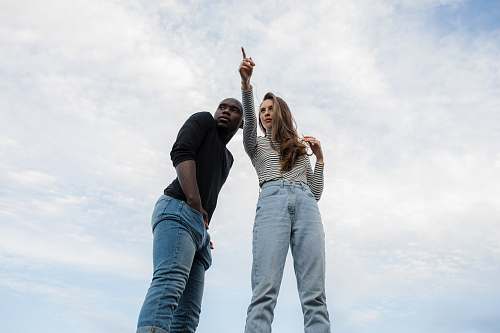 human photography of woman pointing her finger near an man person