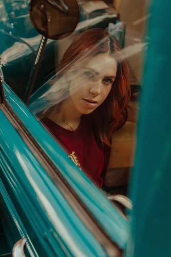 human photography of woman sitting inside the vehicle person