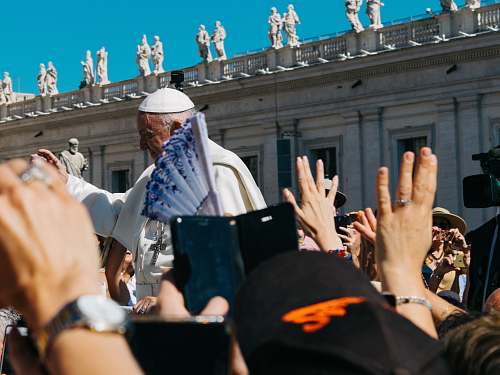 person Pope surrounded with people during daytime human