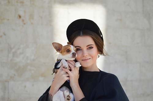 person portrait photo of woman carrying puppy dog