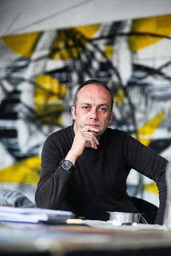 person selective focus photography of man leaning on table human