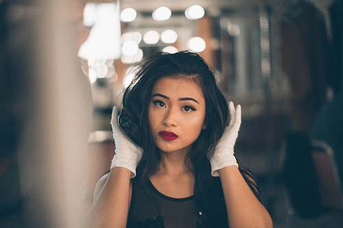 human selective focus photography of woman holding her hair woman