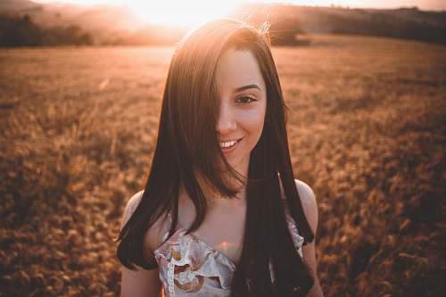 person selective focus photography of woman on grass field woman