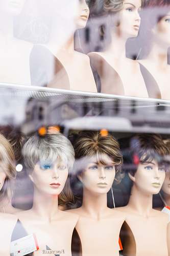 person three assorted-color wigs on practice heads collage human