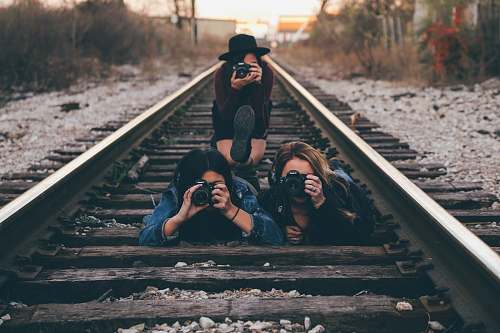 human three women in train railway taking picture photographer
