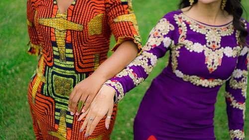 human two women standing on green grass person