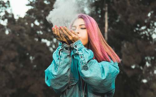 person woman blowing powder off her hands human