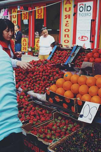 fruit woman buying strawberries at the market food