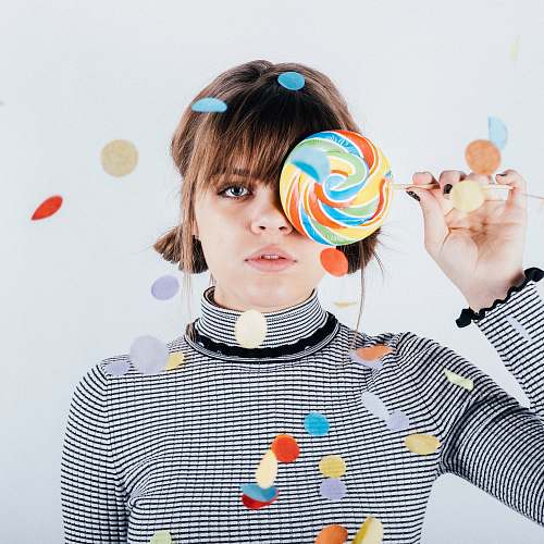 person woman covering her right eye with lollipop human