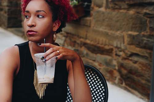 person woman drinking on clear plastic cup woman