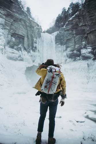 human woman facing frozen waterfalls person