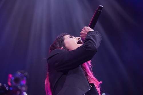 person woman holding microphone while singing human