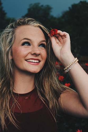 human woman holding red flower person