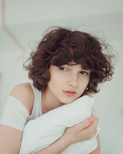 person woman hugging white pillow human